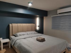 a bedroom with a bed with a pillow on it at Cozy Loft By Hauzcinta @Sunway Grid in Kampong Pendas