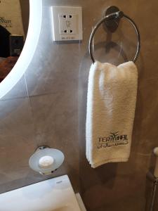 a towel hanging on a wall in a bathroom at Terminal Inn Fully Furnished Hotel & Apartment- Al Mansoura in Doha