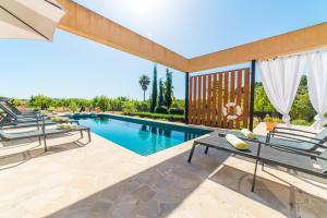a swimming pool with lounge chairs next to a swimming pool at Ideal Property Mallorca - Sa Vinyeta in Selva
