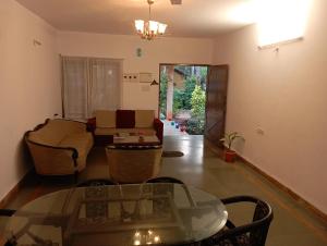 Lobos villa في كالانغيُت: غرفة معيشة مع طاولة زجاجية وأريكة