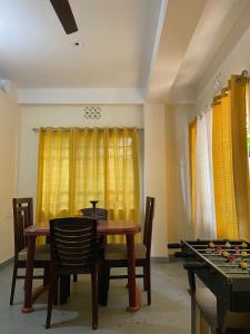 a dining room with a table and a chess board at Maria's Homestay in Siliguri