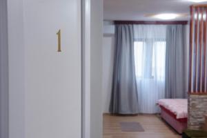 a room with a bed and a window and a door at Apartmani Lučić in Višegrad