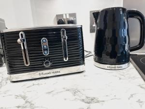 a toaster sitting on a counter next to a coffee pot at The Temple House Balcony Suite in Birmingham