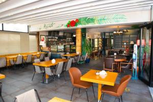 a restaurant with tables and chairs in a room at Hotel Simsek in Edirne