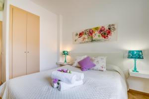 a bedroom with a white bed with towels on it at Ideal Property Mallorca - Casa Pequeña in Crestatx +29 photos