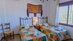 A bed or beds in a room at El Romo Colmenar by Ruralidays