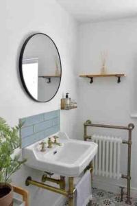 a bathroom with a sink and a mirror at Teach Róise Eoin in Loughanure