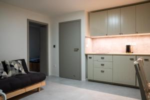a living room with a couch and a kitchen at Apartmán Emilka in Janov nad Nisou