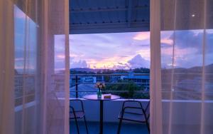 a balcony with a table and two chairs and a view at Baan Ban Dalay in Ao Nang Beach