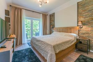 a bedroom with a bed and a brick wall at Casa Nostalgia in Poiana Brasov