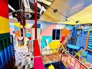 a room filled with lots of different colored umbrellas at La Fuente House Hostel in Constanza