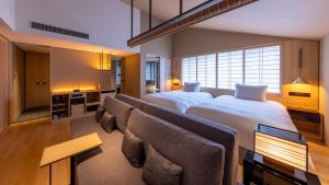a hotel room with two beds and a couch at Fufu Kyoto in Kyoto