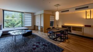 a living room with a table and a kitchen at Fufu Kyoto in Kyoto