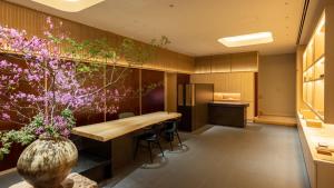 a conference room with a table and flowers in a vase at Fufu Kyoto in Kyoto