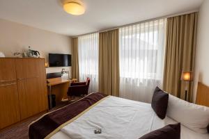 Postel nebo postele na pokoji v ubytování Comfort Hotel tom Kyle