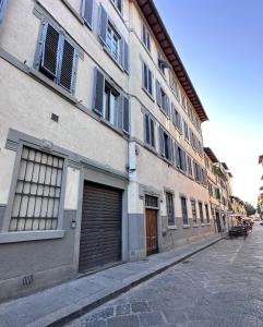 a building with two garage doors on a street at eLLe Apartments Firenze in Florence