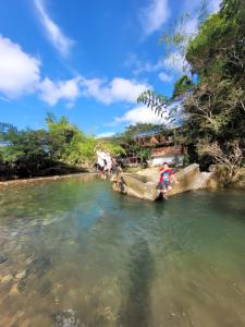 a group of people in the water on a river at Estadero y Hospedaje las Pavas in Norcasia