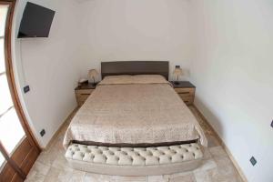 a bedroom with a large bed in a room at Agriturismo Rihane in Sinio