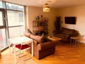 a living room with a couch and a table at Cardiff City centre Apartment lifestyle!! in Cardiff