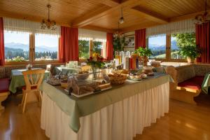 a long table with food on it in a room at Hotel Tischlbergerhof in Ramsau am Dachstein