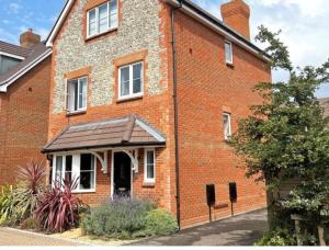 a red brick building with a porch on it at Angmering Home in Angmering