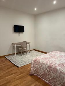 1 dormitorio con escritorio y mesa con silla en Frida en Viareggio