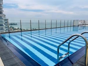 a swimming pool on the roof of a building at Beach Mount Apartment (Blue Ocean Apartment) in Mount Lavinia