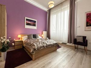 A bed or beds in a room at ABT Apartments Karoly