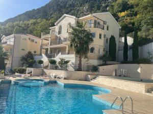 a large swimming pool in front of a building at Stunning view to Kotor bay and Old town - C2 Vista in Muo