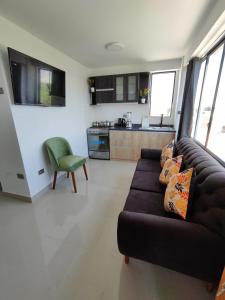 a living room with a couch and a kitchen at Departamentos en Camaná in Camaná