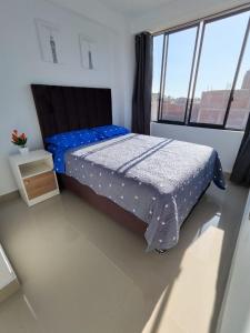 Una cama o camas en una habitación de Departamentos en Camaná
