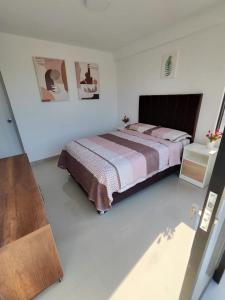 a bedroom with a bed in a white room at Departamentos en Camaná in Camaná