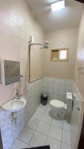 a bathroom with a toilet and a sink at Hostel Mar in São Luís