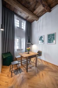 a dining room with a wooden table and chairs at TORhaus Appartments Sendenhorst in Sendenhorst