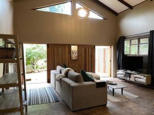a living room with a couch and a tv at Stacey's Cornerstone Studio Apartment in Hillcrest