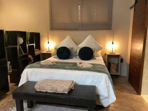 a bedroom with a large bed with two pillows at Stacey's Cornerstone Studio Apartment in Hillcrest