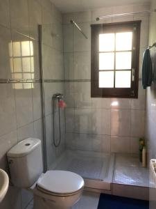 y baño con ducha, aseo y lavamanos. en Agradable casa con chimenea interior, en Camprodon