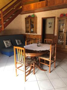 a dining room with a table and chairs and a couch at Agradable casa con chimenea interior in Camprodon