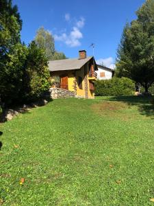 a house with a large yard in front of it at Agradable casa con chimenea interior in Camprodon