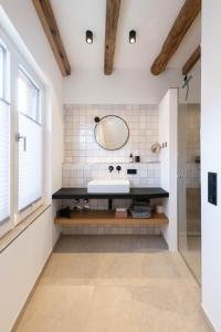 a bathroom with a sink and a mirror at TORhaus Appartments Sendenhorst in Sendenhorst