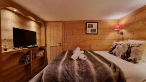 a bedroom with a bed with a towel on it at So cosy Val Thorens in Val Thorens