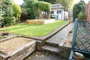 un patio con jardín y un patio con escaleras en Stylish 3 Bedroom House Near NEC, City Centre, en Birmingham