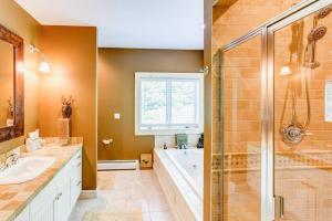 a bathroom with a shower and a tub and a sink at Bovina Mountain High in Bovina Center +36 photos