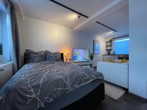 ein Schlafzimmer mit einem Bett und einem TV in der Unterkunft Gleis 12 , kontaktloser 24-7-Check In, barrierefrei ,Smart TV, W-LAN, Parkplatz kostenlos in Bückeburg