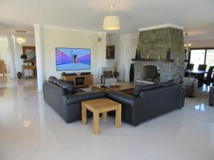 a living room with two couches and a fireplace at VILLA Casa Eden in Vila Nova De Cacela