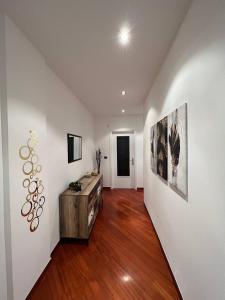 a living room with white walls and wood floors at Antares In Puglia in Monopoli