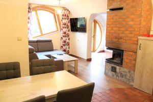 a living room with a table and a fireplace at Wodny Świat in Ostrzyce