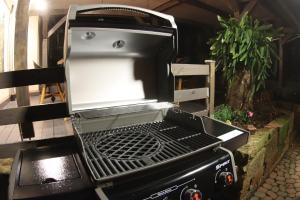 a grill is sitting on a patio at The Birdy Mountains Luxury Lodge 2 in Schlitz