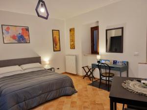 a bedroom with a bed and a table and a desk at G.S House in LʼAquila