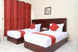 Postel nebo postele na pokoji v ubytování Ruwi Beach Hotel Apartments - MAHA HOSPITALITY GROUP